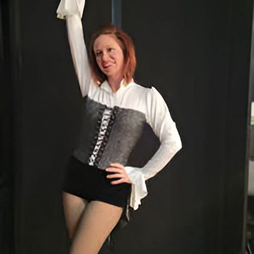 Person posing in corset and shorts outfit.