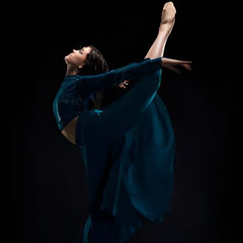 Dancer performing a graceful high kick.