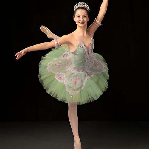 Ballet dancer in green tutu performing pose.