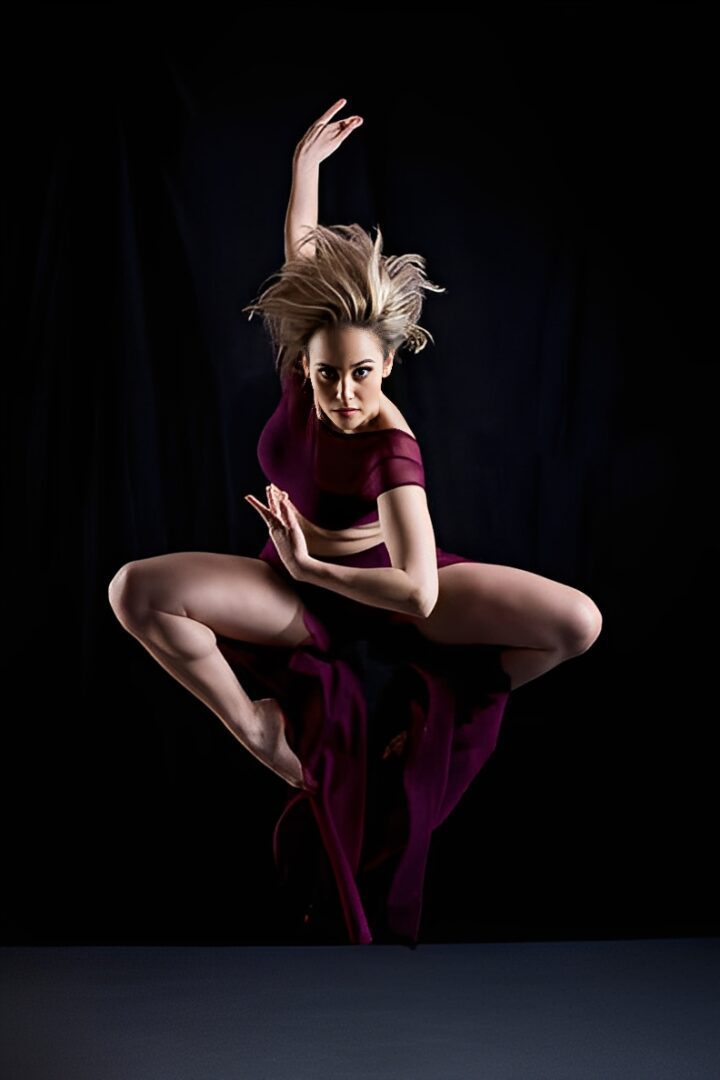 Dancer leaping in mid-air, dramatic pose.