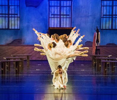 Ballet dancers forming a fan on stage
