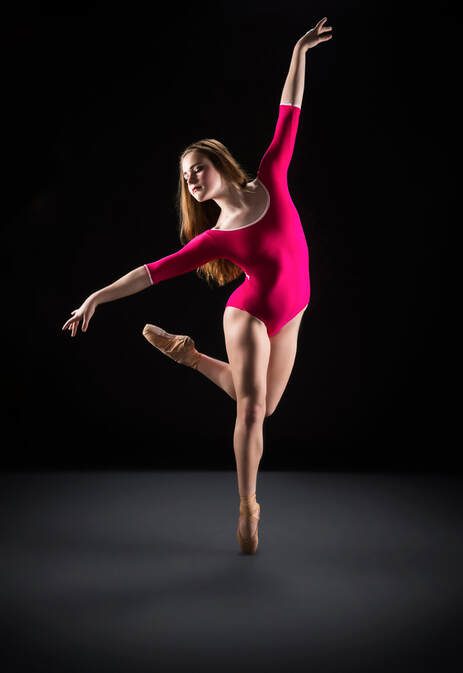 Ballerina in pink leotard on pointe